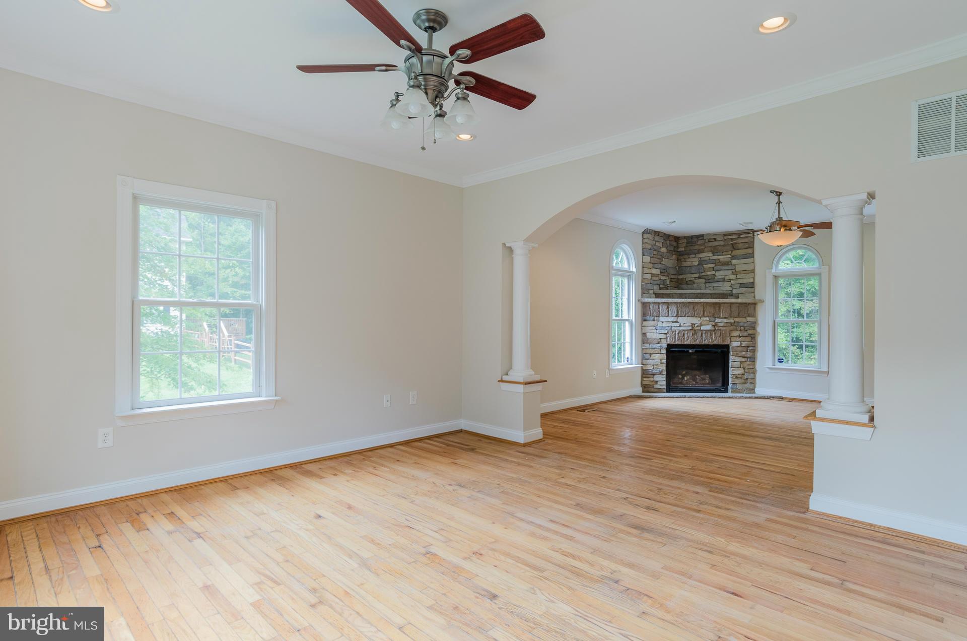 3902 Goose Harbor Road Middle River, MD 21220 - Photo 2 of 30 wooden floor fireplace and windows in an empty room