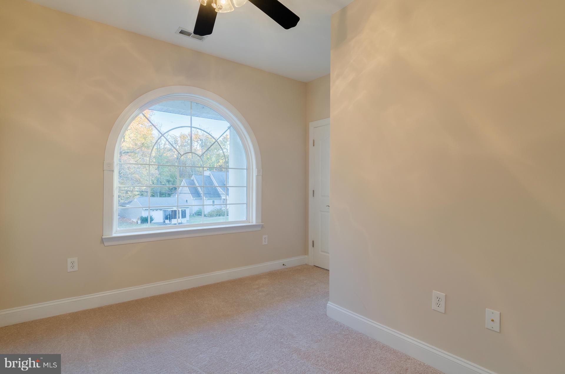 3902 Goose Harbor Road Middle River, MD 21220 - Photo 15 of 30 an empty room with windows and ceiling fan