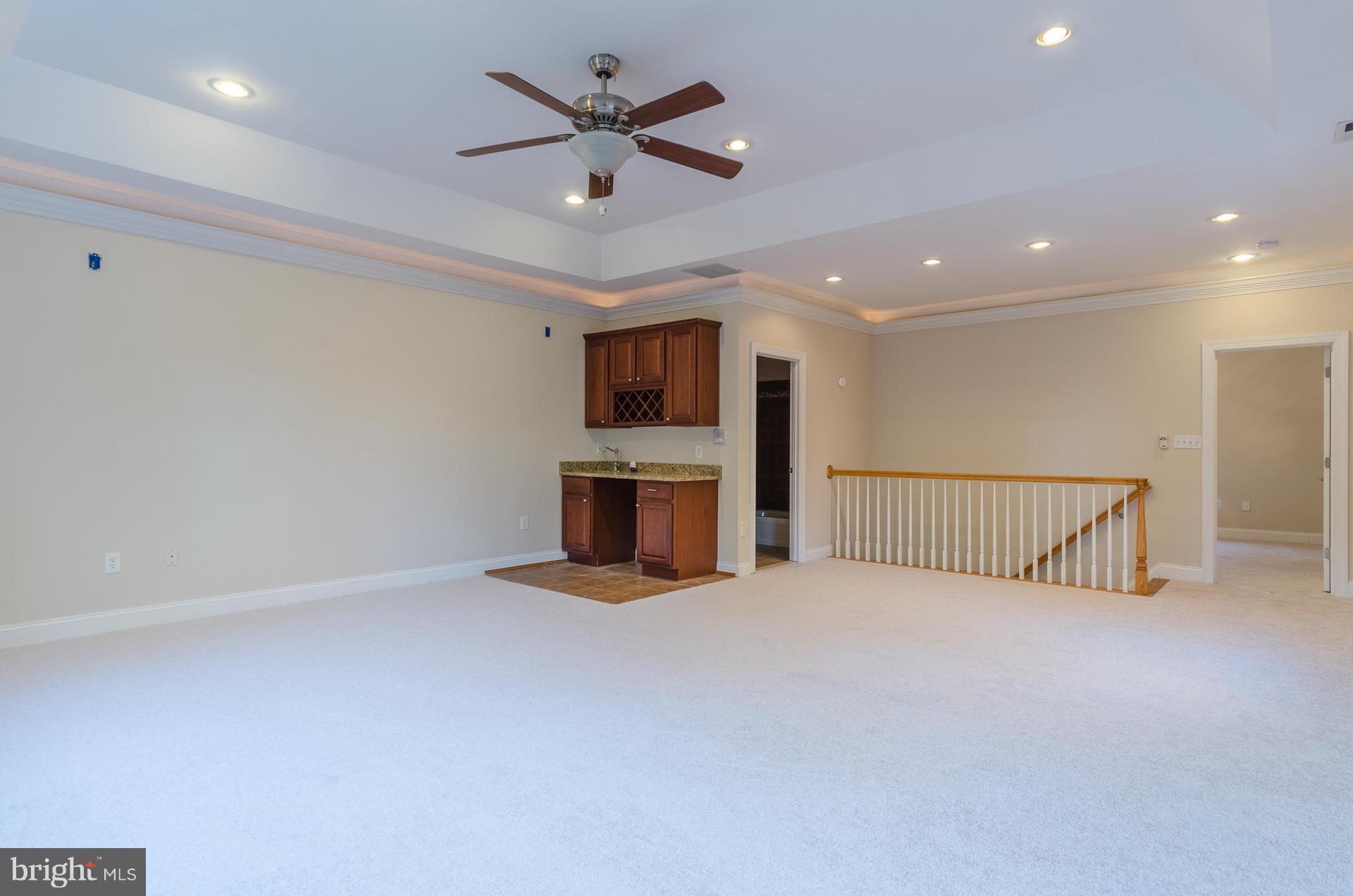 3902 Goose Harbor Road Middle River, MD 21220 - Photo 21 of 30 an empty room with ceiling fan and windows