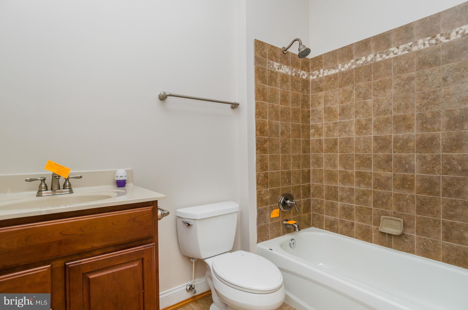 3902 Goose Harbor Road Middle River, MD 21220 - Photo 22 of 30 a white toilet sitting next to a bathroom sink