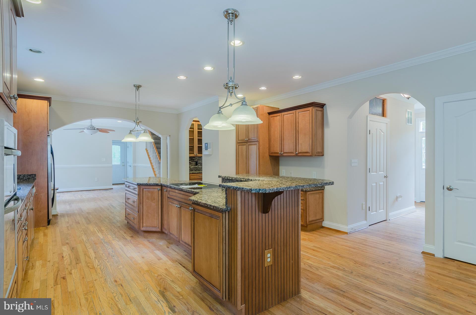 3902 Goose Harbor Road Middle River, MD 21220 - Photo 7 of 30 a kitchen with stainless steel appliances granite countertop wooden floors and view living room