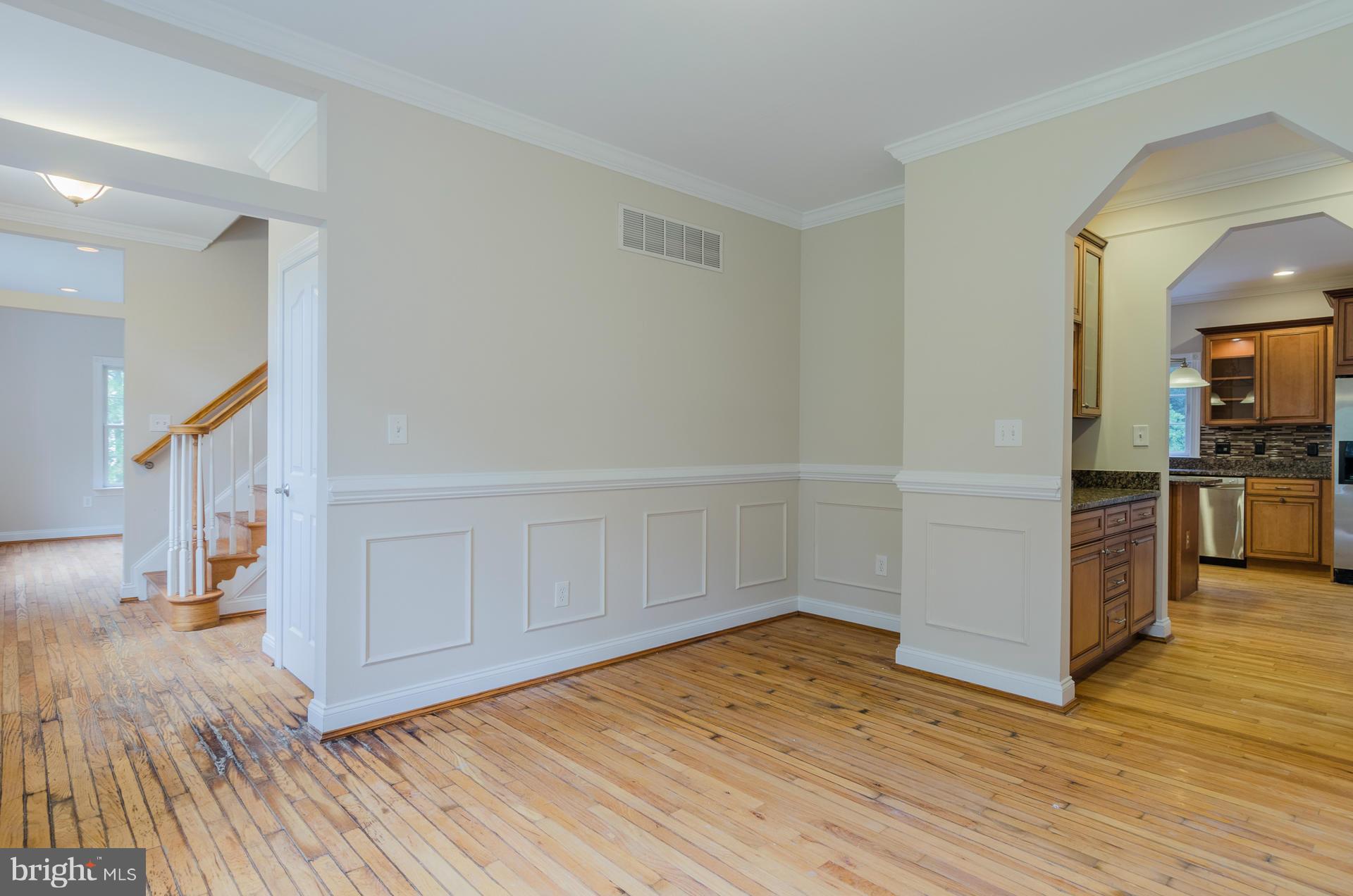 3902 Goose Harbor Road Middle River, MD 21220 - Photo 9 of 30 a view of empty room with wooden floor and kitchen