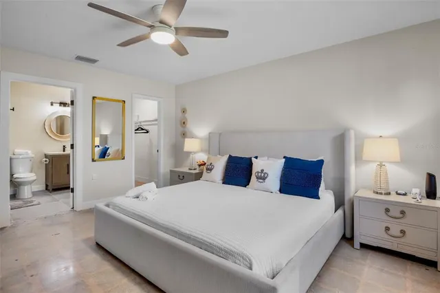 a bed room with a bed and a chandelier