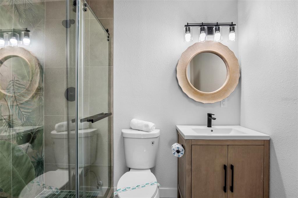 442 62nd Street Holmes Beach, FL 34217 - Photo 13 of 29 a bathroom with a toilet sink and mirror