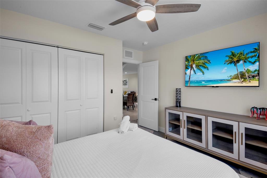 442 62nd Street Holmes Beach, FL 34217 - Photo 15 of 29 a bedroom with a bed and a chandelier
