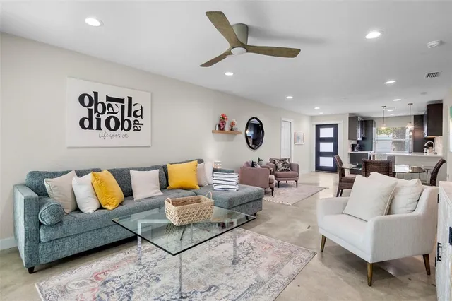 a living room with furniture kitchen view and a couch