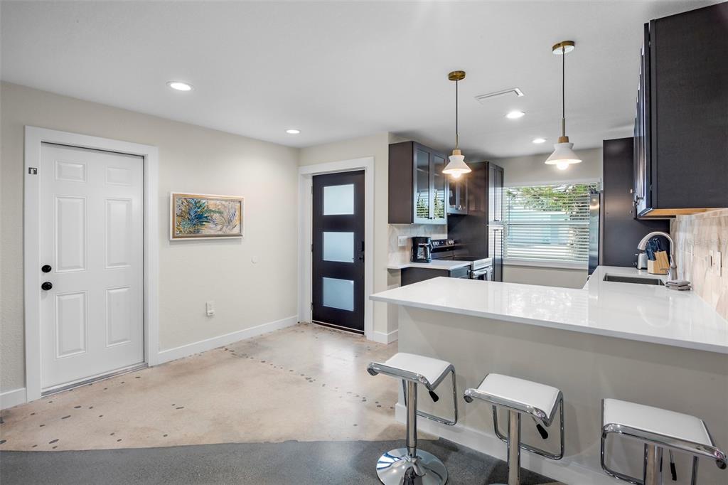 442 62nd Street Holmes Beach, FL 34217 - Photo 4 of 29 a large kitchen with a table and chairs