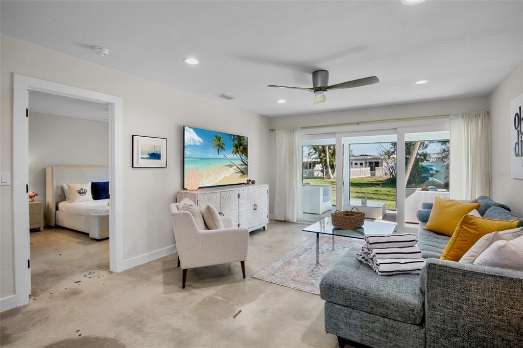 442 62nd Street Holmes Beach, FL 34217 - Photo 10 of 29 a living room with furniture and a flat screen tv