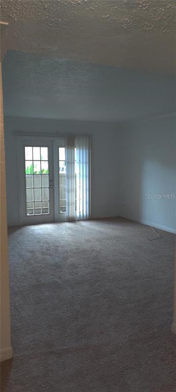 315 Wymore Road, Unit 104 Altamonte Springs, FL 32714 - Photo 3 of 10 a view of an empty room with a fireplace