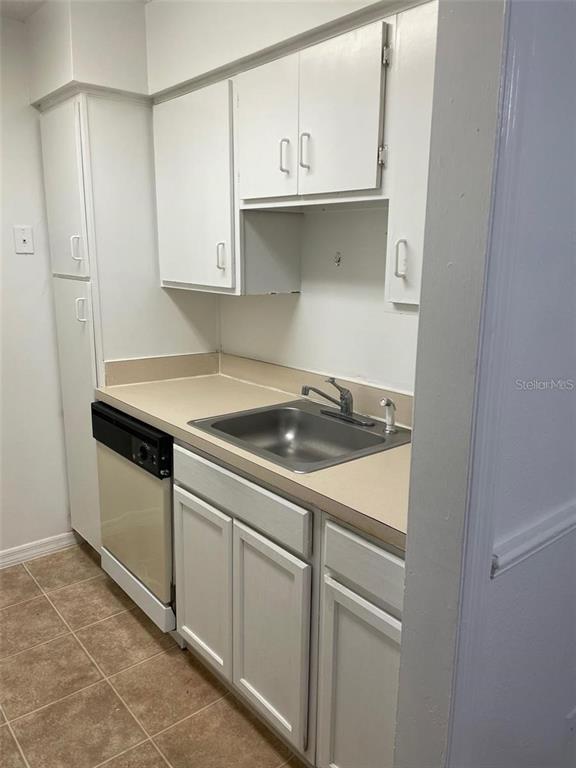 315 Wymore Road, Unit 104 Altamonte Springs, FL 32714 - Photo 4 of 10 a kitchen with white cabinets and white appliances