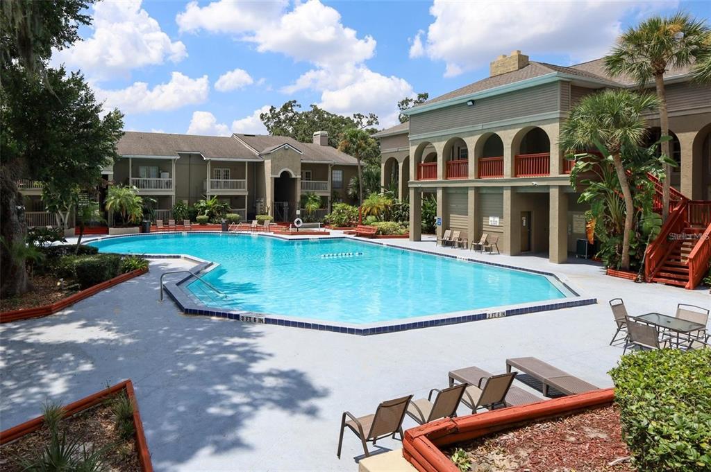 315 Wymore Road, Unit 104 Altamonte Springs, FL 32714 - Photo 10 of 10 a view of a white house with a yard patio and fire pit