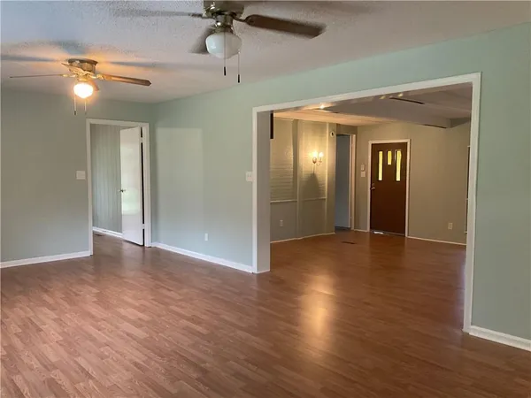 a view of a hallway with wooden floor