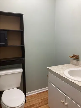 a white toilet sitting next to a bathroom sink