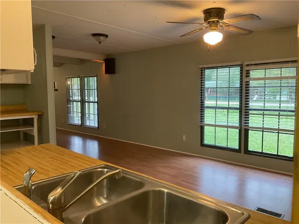 a room with pool table and windows
