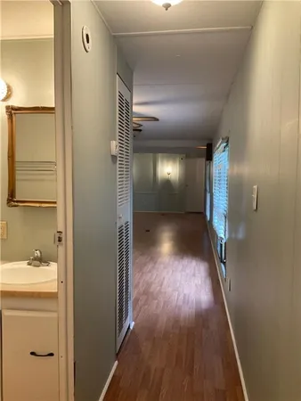 a view of a room with wooden floors and lots of windows
