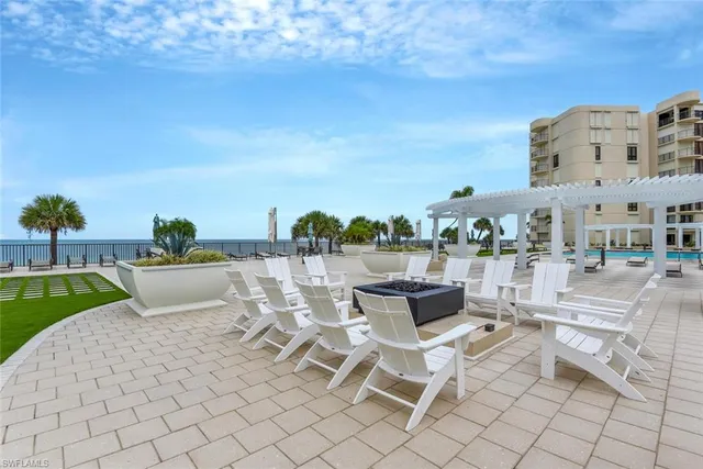 a view of a terrace with lawn chairs
