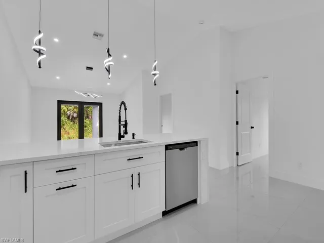 a spacious bathroom with double vanity and a mirror