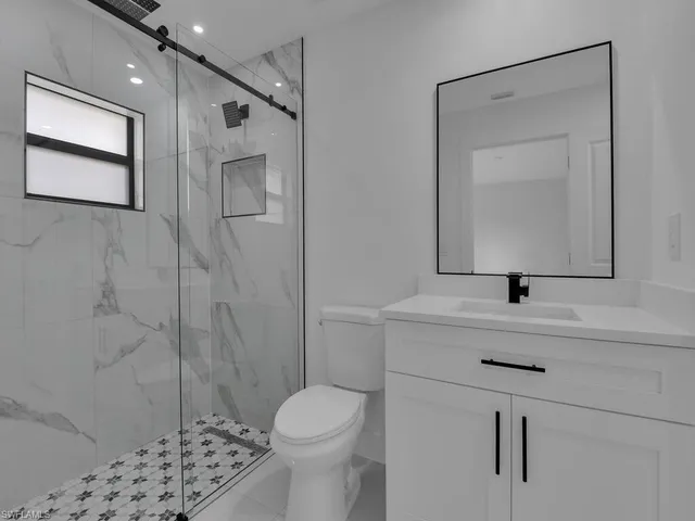 a bathroom with a sink toilet and shower