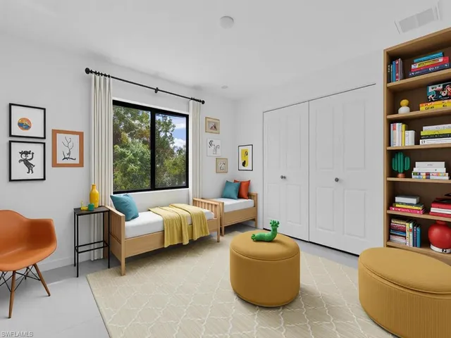 a living room with furniture and a book shelf