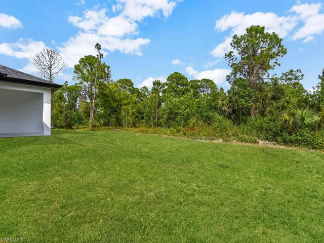a backyard of a house with lots of green space