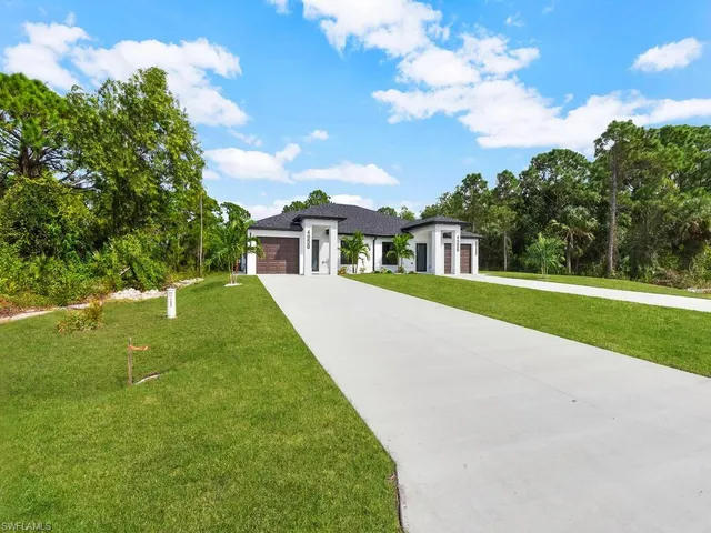 a view of yard with swimming pool and green space