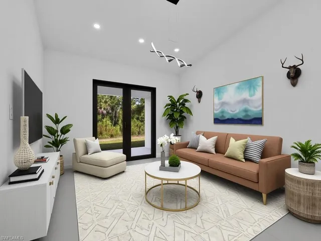 a living room with furniture potted plant and window