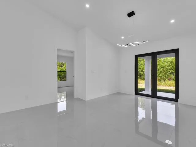 a spacious bedroom with a bed a couch and a window