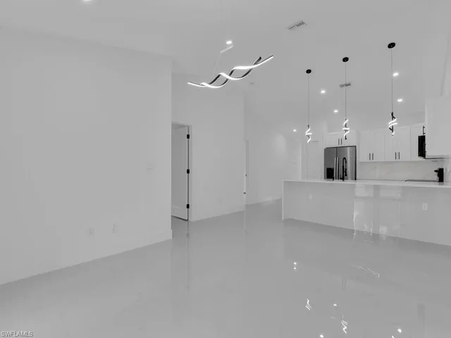 a view of a kitchen with a sink and a large mirror