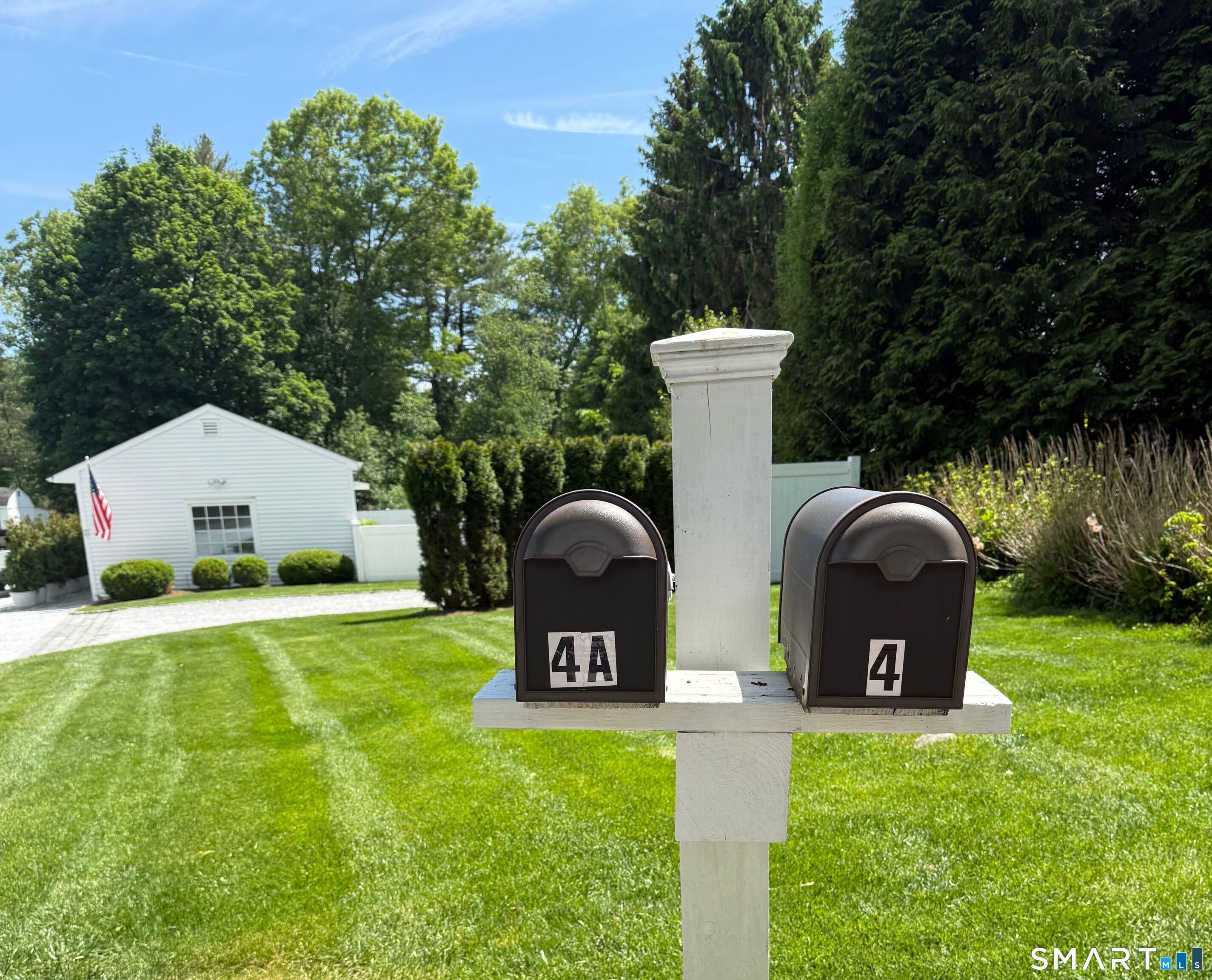 4 A Stoneboat Road Westport, CT 06880 - Photo 2 of 24 a front view of a house with a garden