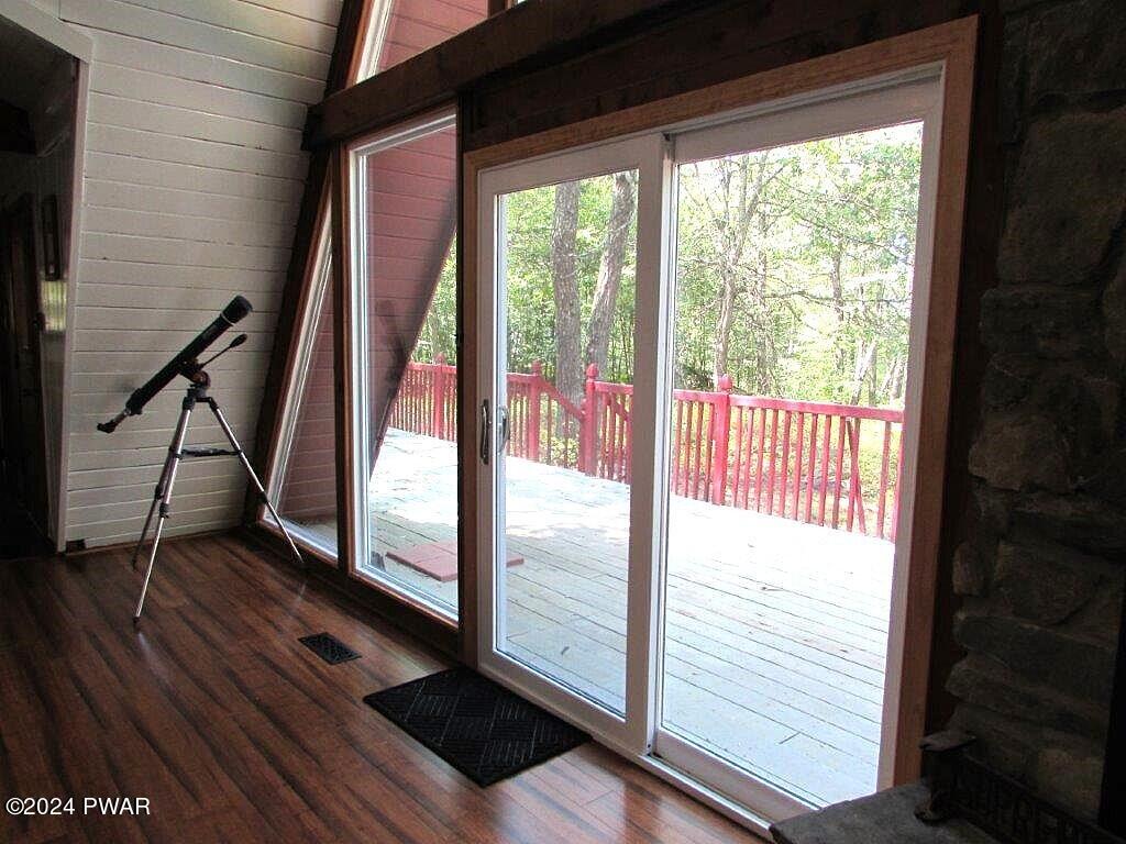 807 Rimrock Court Hawley, PA 18428 - Photo 24 of 41 a view of an empty room with wooden floor and windows