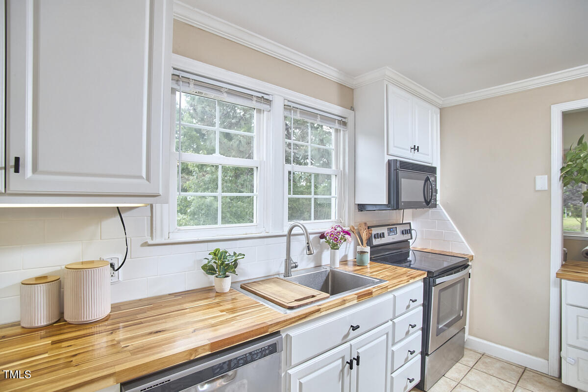 909 Goodwin Road Durham, NC 27712 - Photo 11 of 52 a kitchen with a sink and a window