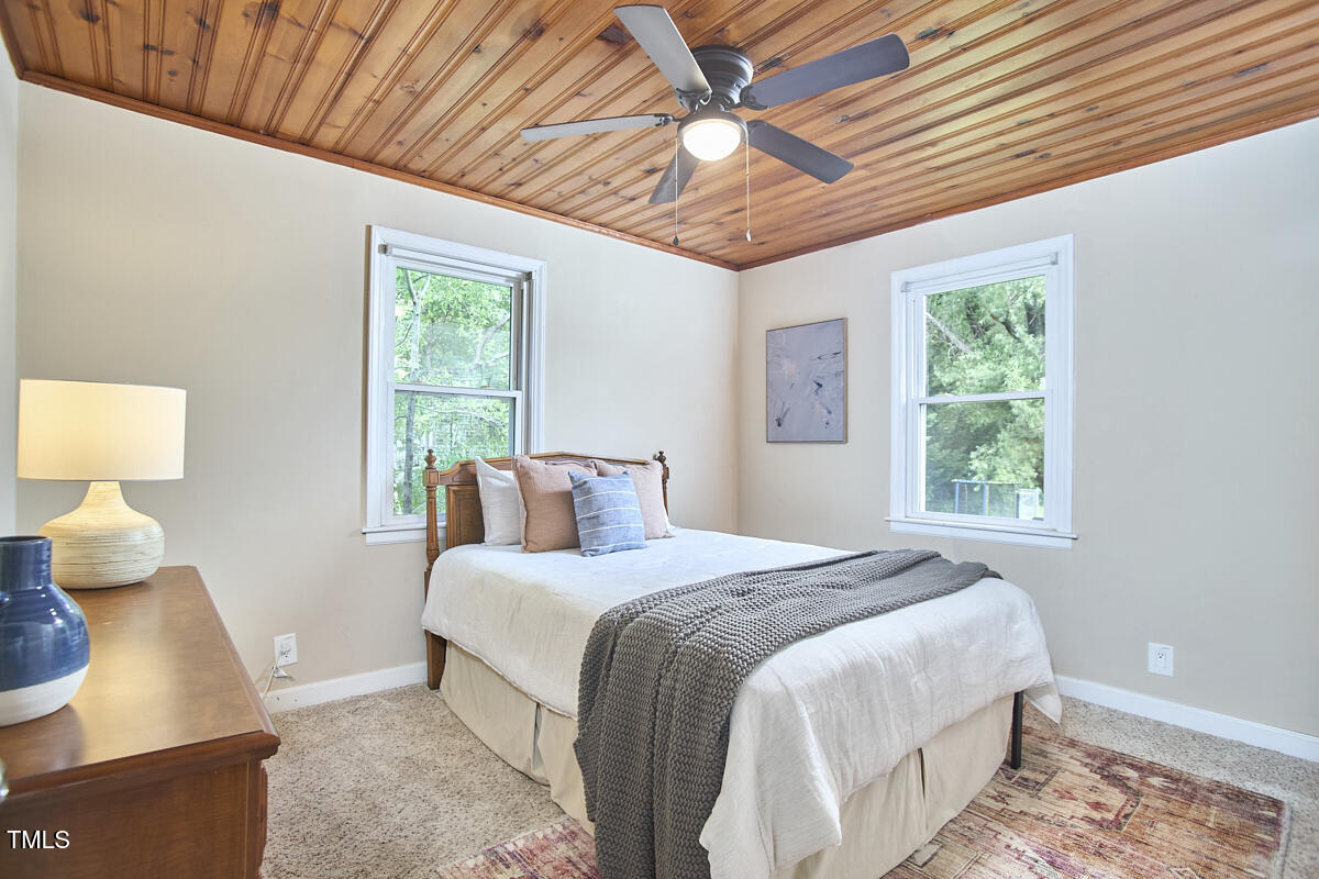 909 Goodwin Road Durham, NC 27712 - Photo 14 of 52 a bedroom with a large bed and a window