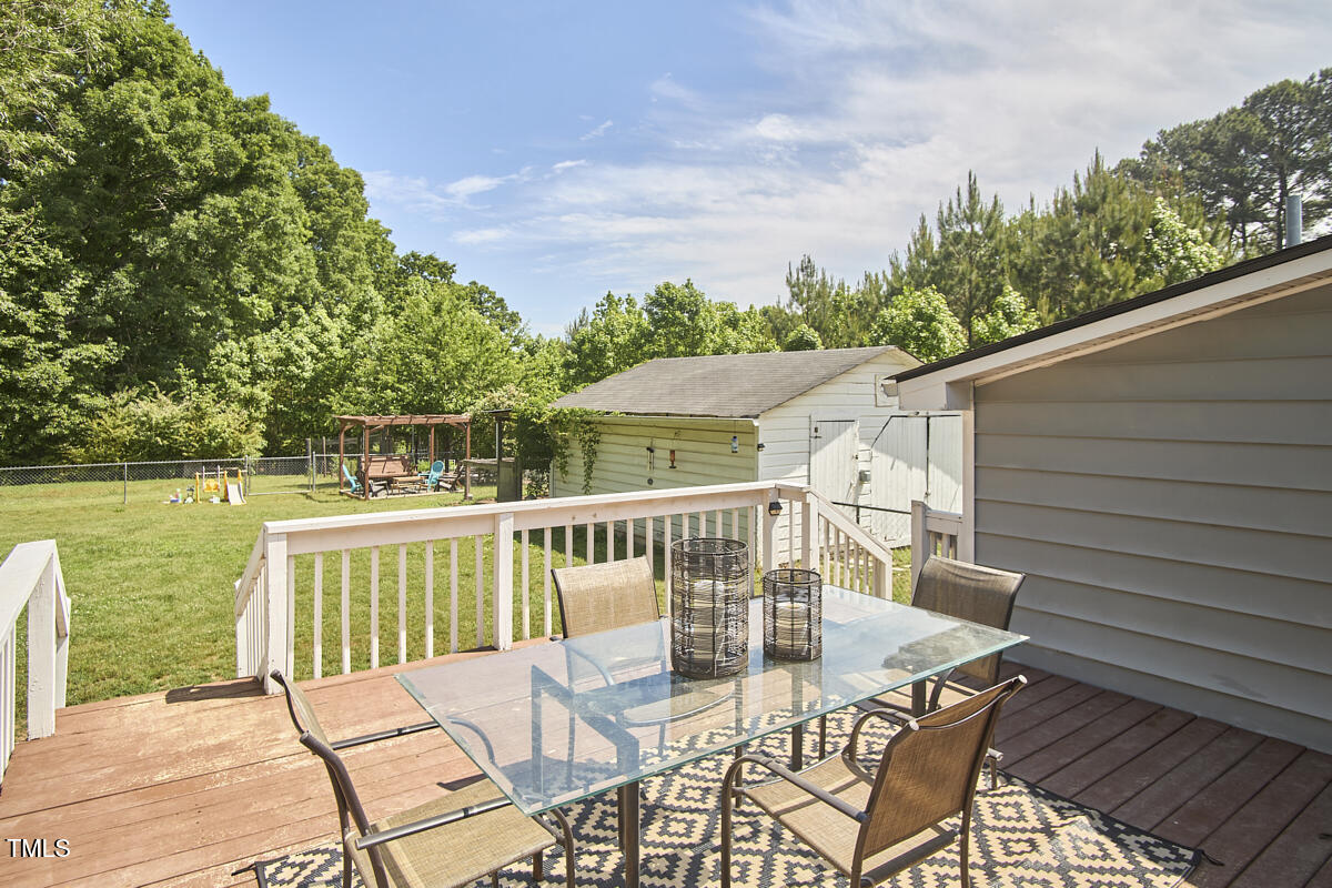 909 Goodwin Road Durham, NC 27712 - Photo 21 of 52 a view of a patio with a table chairs and wooden floor