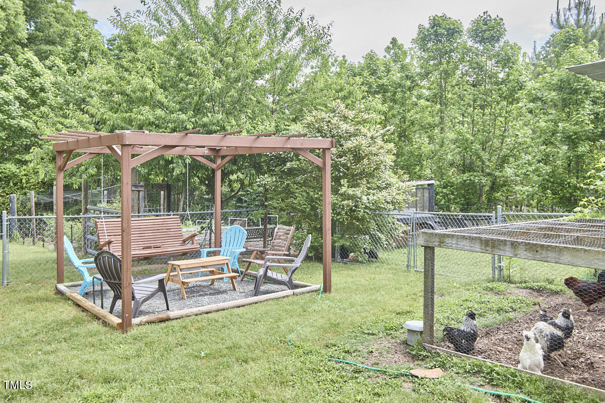 909 Goodwin Road Durham, NC 27712 - Photo 41 of 52 a view of a chair and tables in the yard