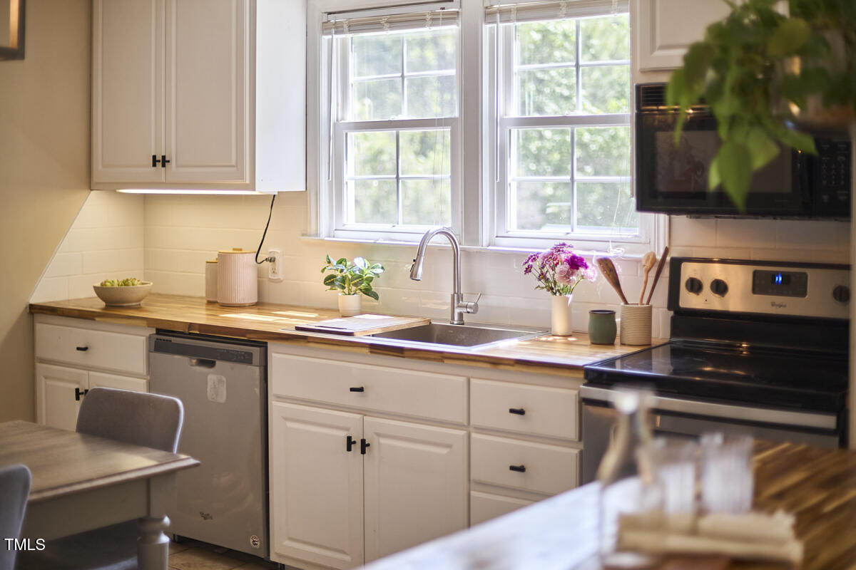 909 Goodwin Road Durham, NC 27712 - Photo 48 of 52 a kitchen with cabinets appliances and a window