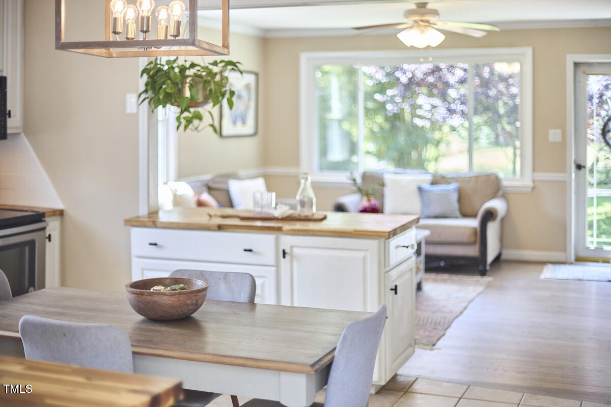 909 Goodwin Road Durham, NC 27712 - Photo 50 of 52 a living room with furniture and a chandelier