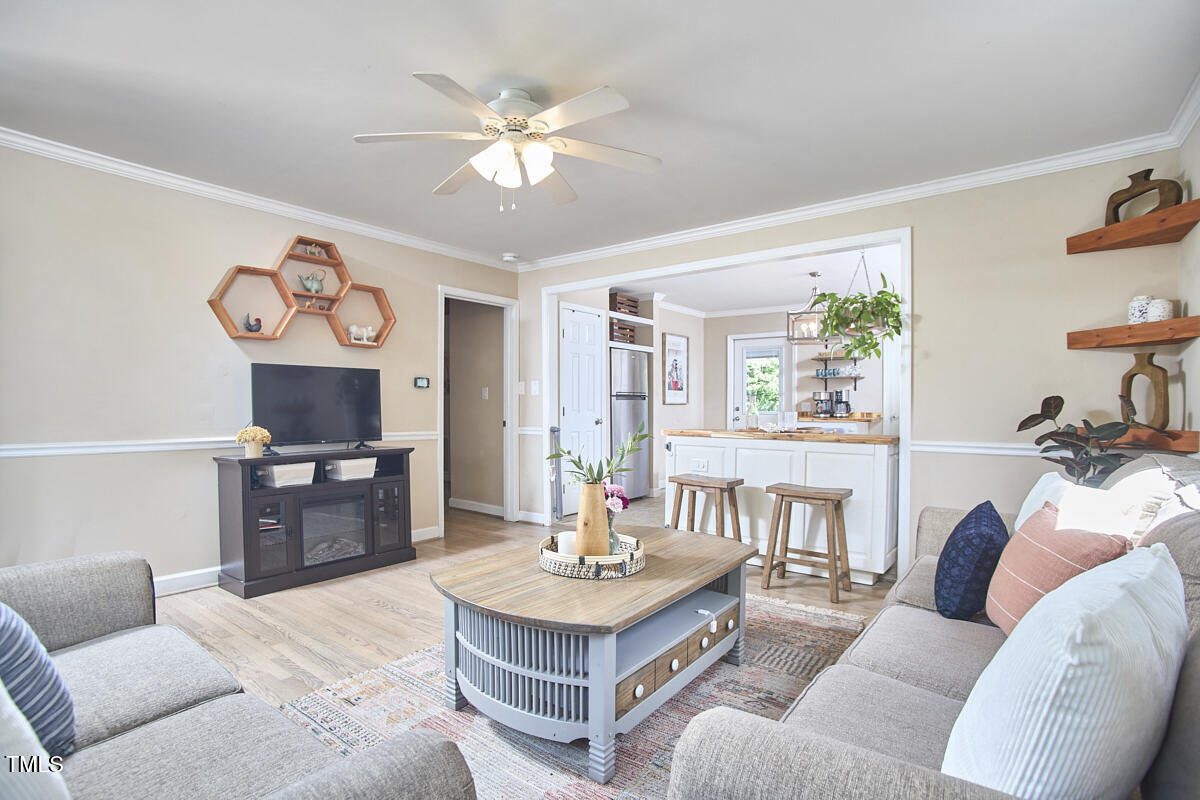 909 Goodwin Road Durham, NC 27712 - Photo 7 of 52 a living room with furniture and a dining table with kitchen view