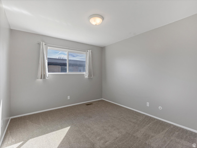 1478 North 75 West, Unit AD Sunset, UT 84015 - Photo 24 of 26 Unfurnished room with light colored carpet and baseboards