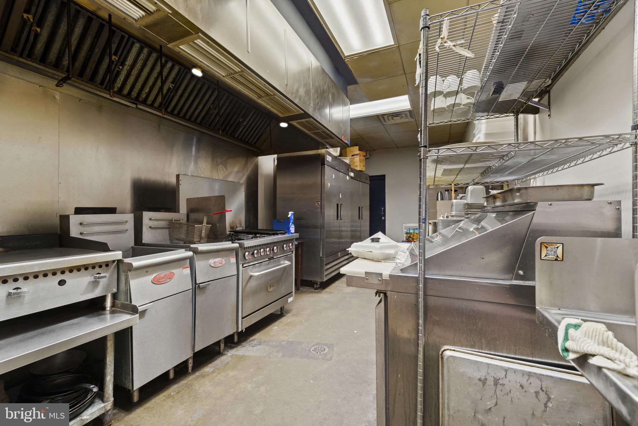3418 Eastern Avenue Baltimore, MD 21224 - Photo 24 of 53 a kitchen with stainless steel appliances granite countertop a sink a stove and cabinets