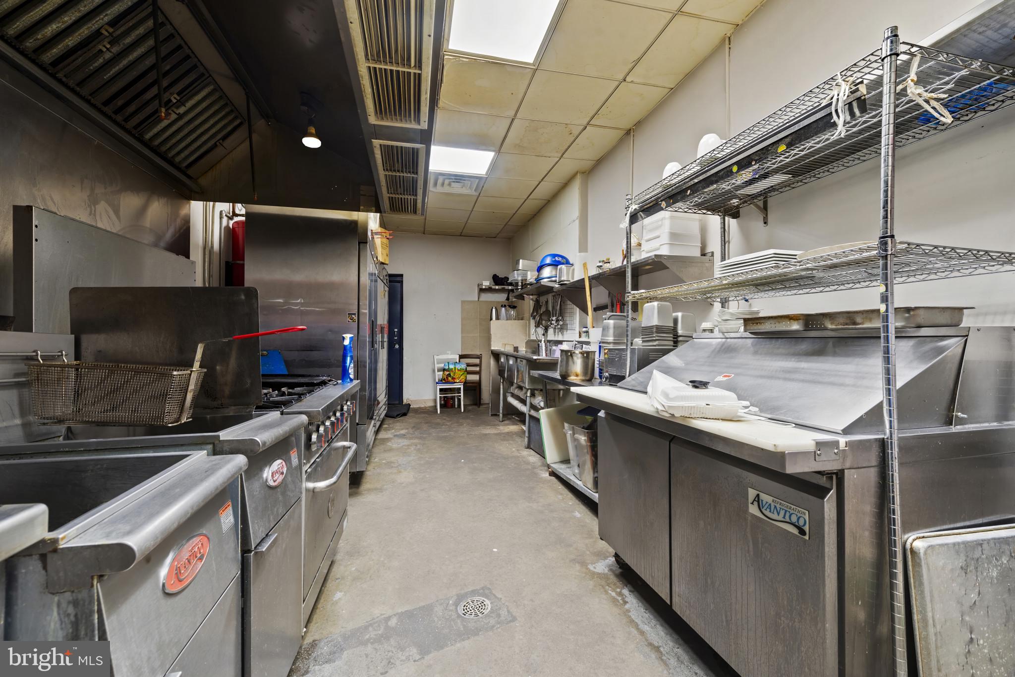 3418 Eastern Avenue Baltimore, MD 21224 - Photo 25 of 53 a kitchen with stainless steel appliances granite countertop a sink a stove and a wooden cabinets