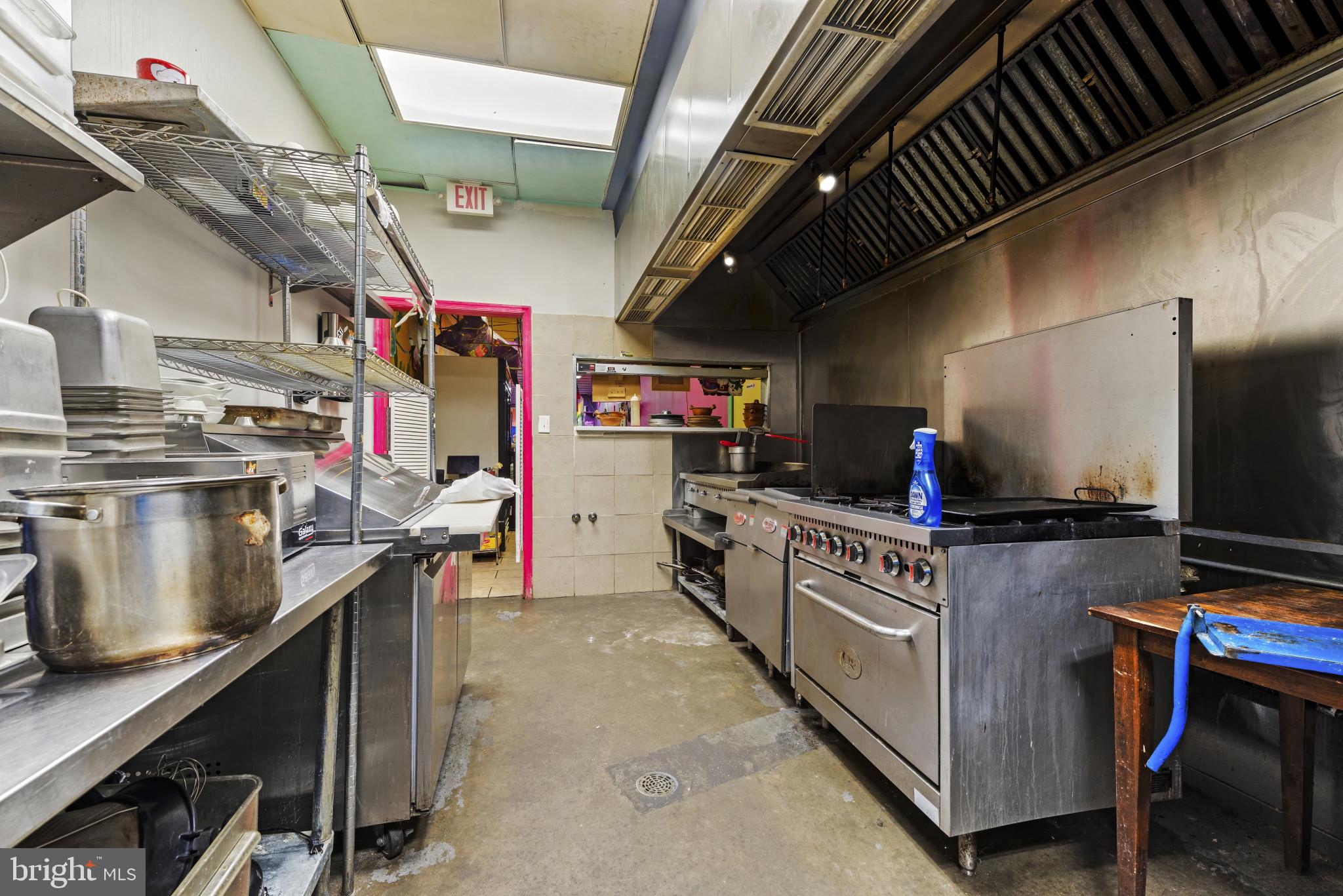 3418 Eastern Avenue Baltimore, MD 21224 - Photo 26 of 53 a kitchen with stainless steel appliances granite countertop a stove and cabinets