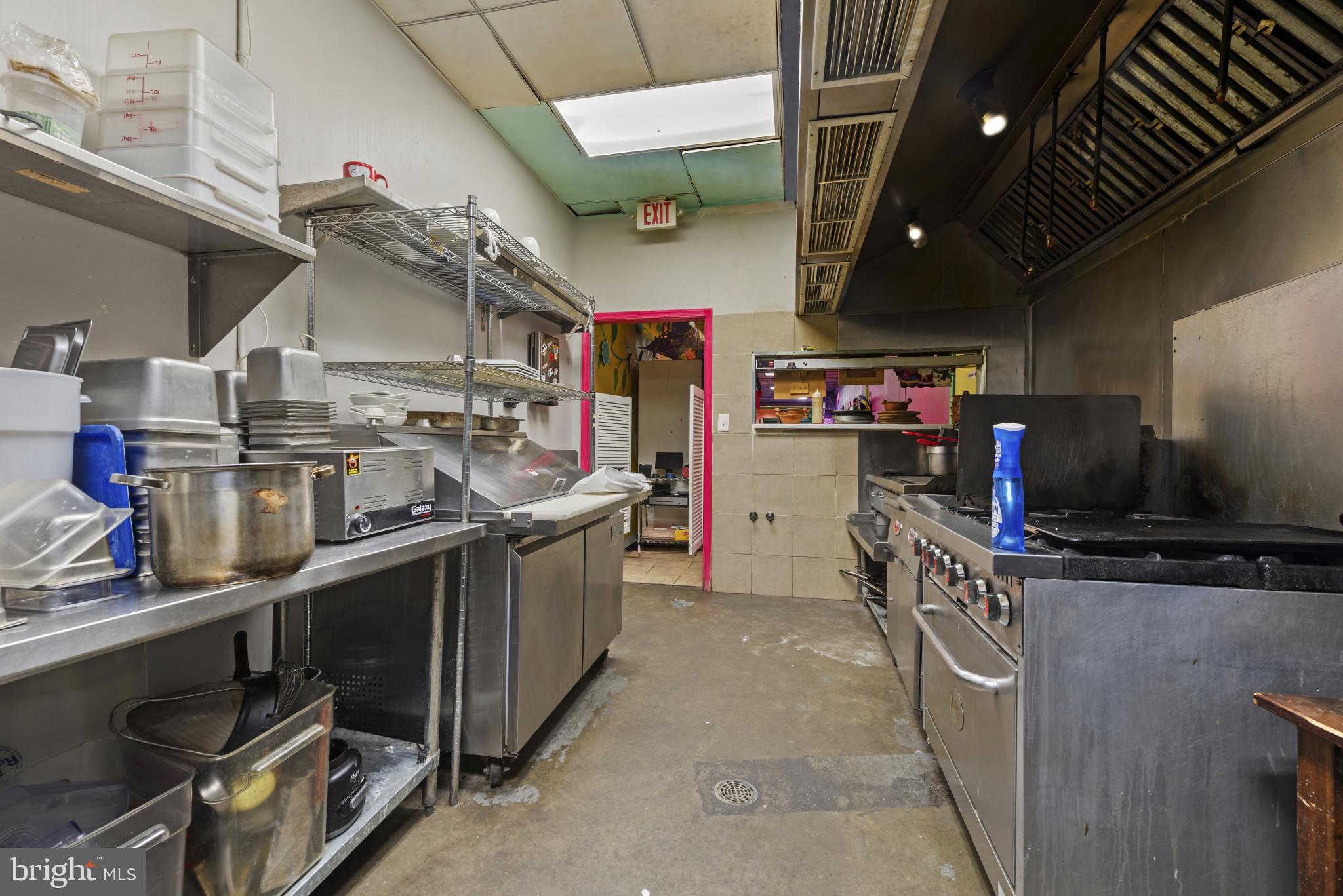 3418 Eastern Avenue Baltimore, MD 21224 - Photo 27 of 53 a kitchen with stainless steel appliances granite countertop a sink and a stove