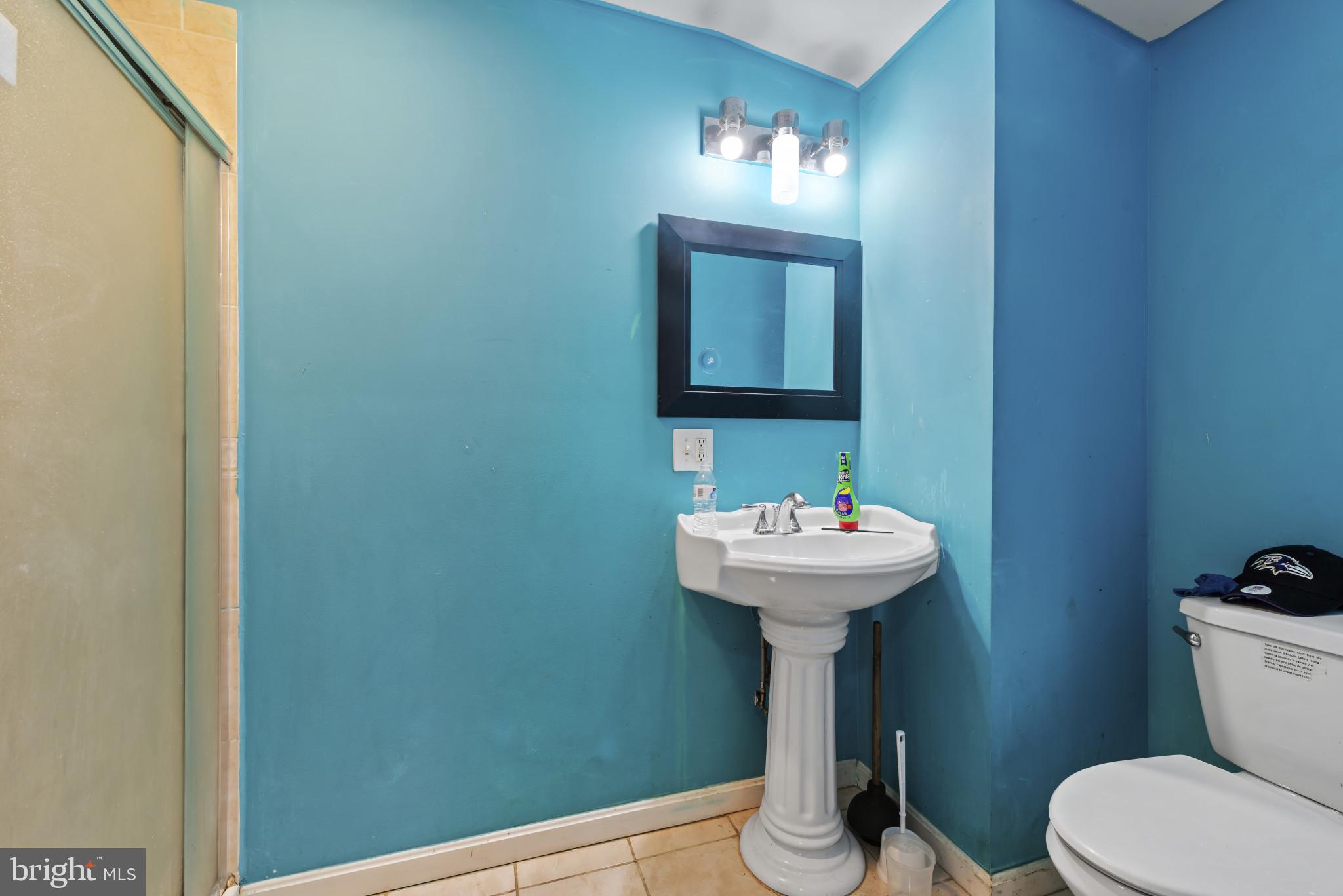 3418 Eastern Avenue Baltimore, MD 21224 - Photo 34 of 53 a bathroom with a sink a toilet and mirror