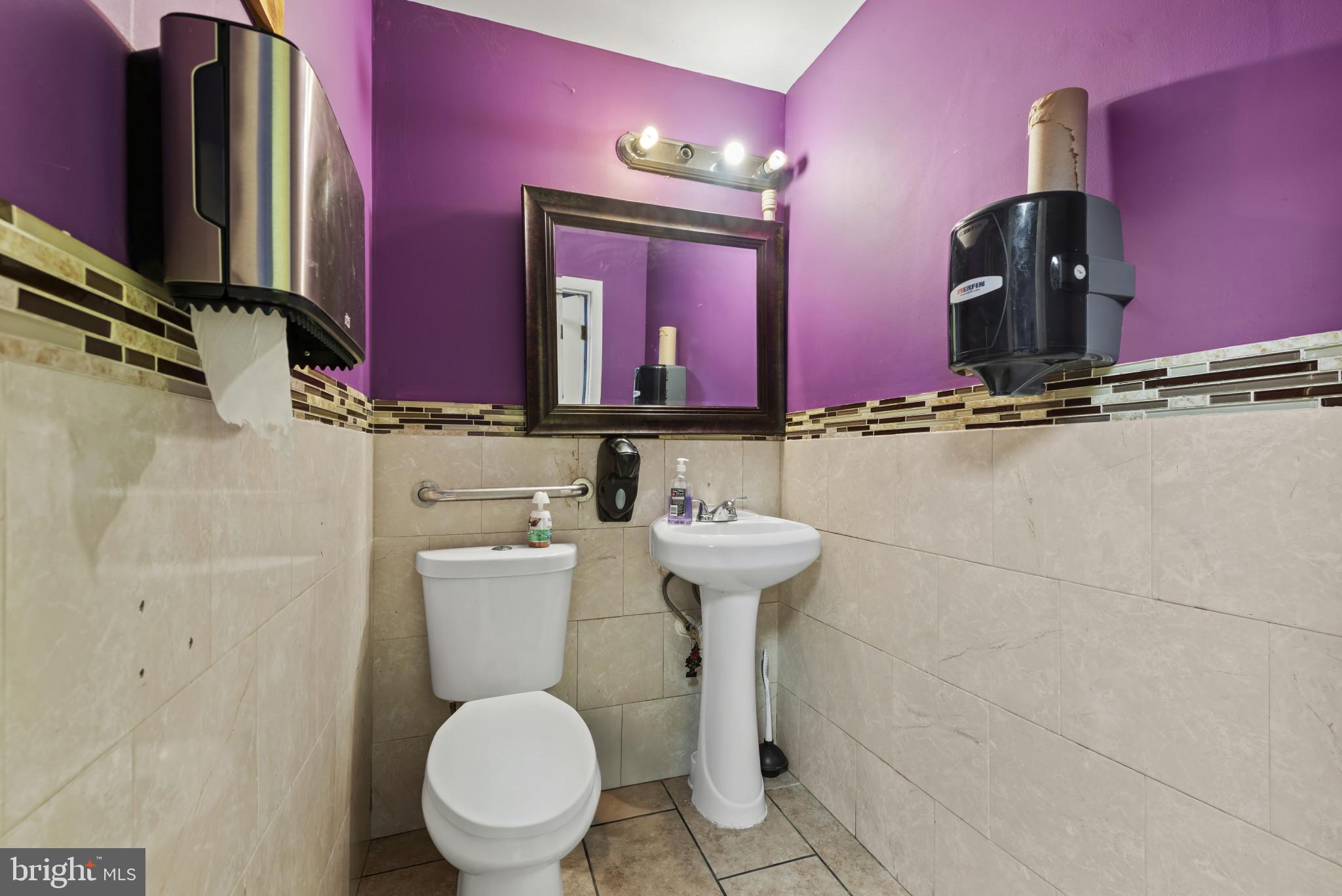 3418 Eastern Avenue Baltimore, MD 21224 - Photo 36 of 53 a bathroom with a toilet sink and mirror