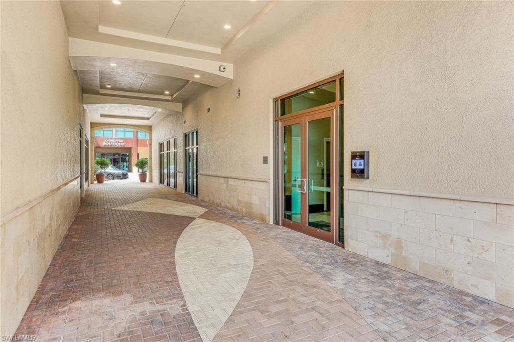 9123 Strada Place, Unit 7201 Naples, FL 34108 - Photo 24 of 50 view of a hallway with wooden floor and a living room