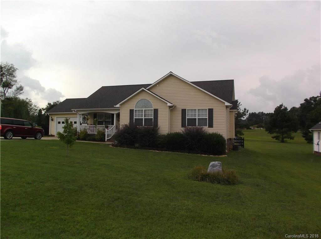 136 Maple Ridge Circle Salisbury, NC 28147 - Photo 1 of 23 a front view of a house with a garden