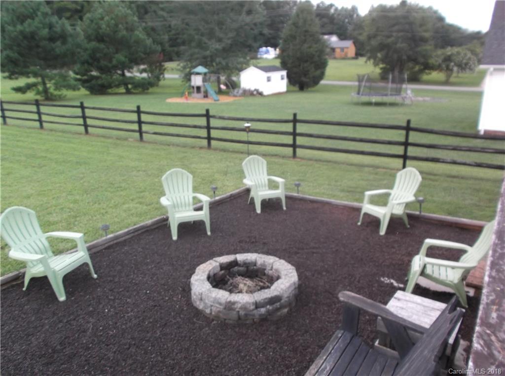 136 Maple Ridge Circle Salisbury, NC 28147 - Photo 15 of 23 a view of a lawn chairs and a table in the back yard
