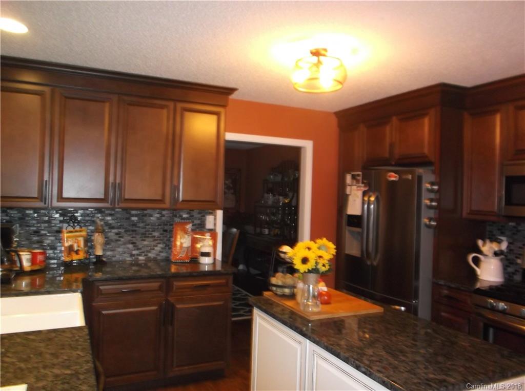 136 Maple Ridge Circle Salisbury, NC 28147 - Photo 16 of 23 a kitchen with stainless steel appliances granite countertop sink stove and refrigerator