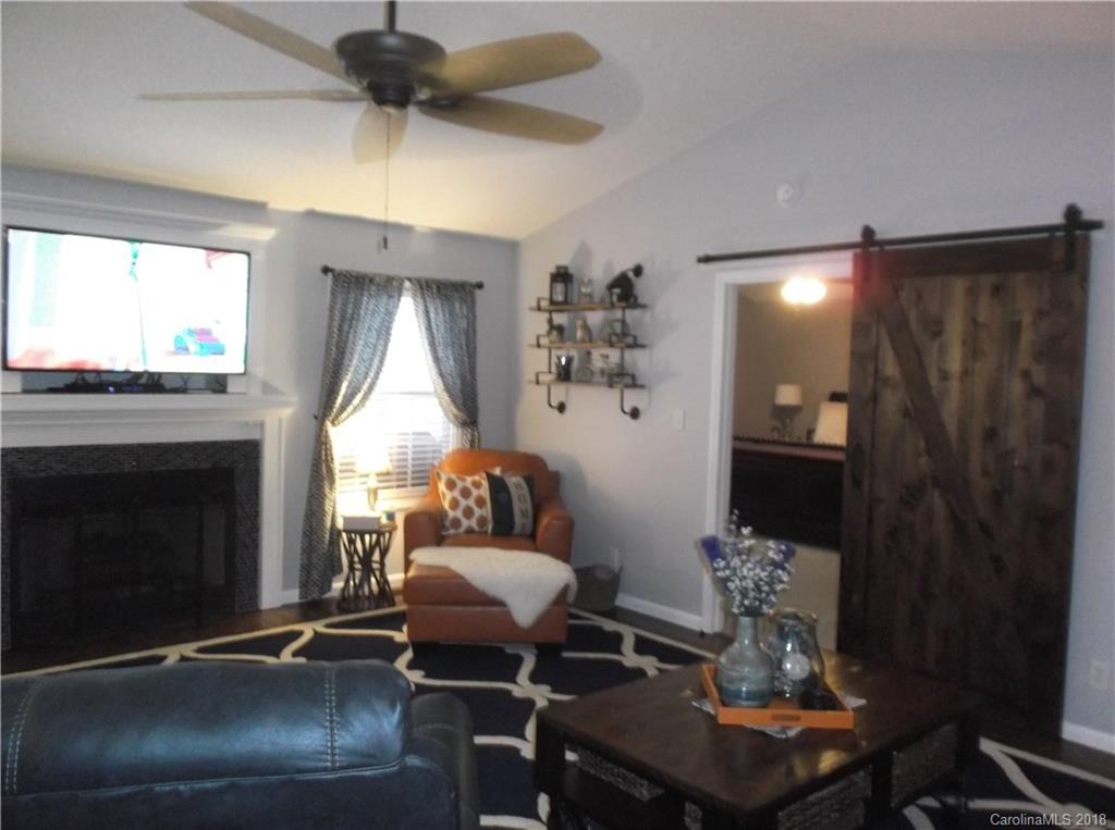 136 Maple Ridge Circle Salisbury, NC 28147 - Photo 19 of 23 a living room with furniture a window and a fireplace