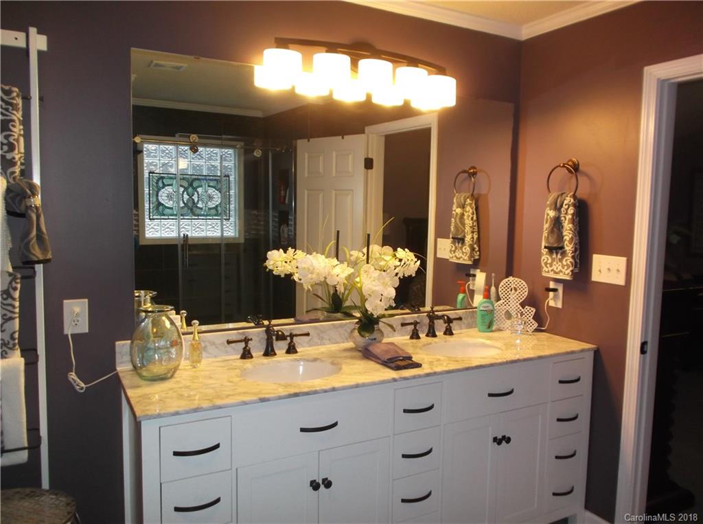 136 Maple Ridge Circle Salisbury, NC 28147 - Photo 22 of 23 a bathroom with double sink and a mirror